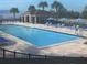 Sparkling pool with lounge chairs and umbrellas for relaxing on sunny days at 331 Ridgemark Ave, Groveland, FL 34736