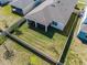 Aerial view of a well-maintained backyard with a screened-in patio and white privacy fence at 4012 Meandering Bay Dr, Apopka, FL 32712