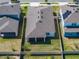 Aerial view of home, roof, back yard, patio and privacy fence at 4012 Meandering Bay Dr, Apopka, FL 32712