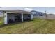 Home's back yard and screen-enclosed back porch at 4012 Meandering Bay Dr, Apopka, FL 32712