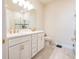Bright bathroom featuring white cabinets, double vanity, brushed gold fixtures, and tile flooring at 4012 Meandering Bay Dr, Apopka, FL 32712