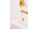 Close up of golden bathtub fixtures in a modern bathroom at 4012 Meandering Bay Dr, Apopka, FL 32712