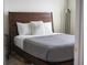 Cozy bedroom featuring a wooden bed frame, soft textures, and natural light at 4012 Meandering Bay Dr, Apopka, FL 32712