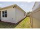 Side of home and back yard feature privacy fence, green lawn, and mulched area at 4012 Meandering Bay Dr, Apopka, FL 32712