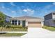 Charming single-Gathering home featuring a two-car garage and beautifully landscaped front yard at 4012 Meandering Bay Dr, Apopka, FL 32712