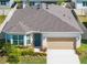 Charming single-story home featuring a well-manicured lawn, attached garage, and lovely front door at 4012 Meandering Bay Dr, Apopka, FL 32712