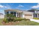 Charming single-story home with manicured landscaping and an attached two-car garage at 4012 Meandering Bay Dr, Apopka, FL 32712