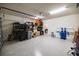 Spacious garage with overhead lighting, epoxy flooring and ample storage shelving at 4012 Meandering Bay Dr, Apopka, FL 32712