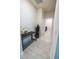 Bright hallway with wood-look flooring and access to the laundry room at 4012 Meandering Bay Dr, Apopka, FL 32712