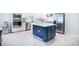 Modern kitchen features stainless steel appliances, white cabinets, and a stylish navy-blue island at 4012 Meandering Bay Dr, Apopka, FL 32712