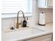 A modern brass faucet complements the stylish undermounted kitchen sink at 4012 Meandering Bay Dr, Apopka, FL 32712