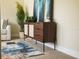 Stylish modern credenza with artwork and a plant accents the living space at 4012 Meandering Bay Dr, Apopka, FL 32712