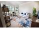 Bright living room with a sofa, desk, and large windows for natural light at 4012 Meandering Bay Dr, Apopka, FL 32712
