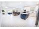Open floorplan showcases a kitchen with a large island, a dining area, and a living room at 4012 Meandering Bay Dr, Apopka, FL 32712