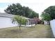 Spacious backyard featuring a screened in porch, small trees, and storage shed at 479 Little Aspen Ct, Ocoee, FL 34761