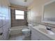 Well-maintained bathroom boasts tile shower and tub, modern vanity, and great lighting at 479 Little Aspen Ct, Ocoee, FL 34761