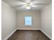 Inviting bedroom offers wood-look flooring, fresh paint, ample natural light, and a ceiling fan at 479 Little Aspen Ct, Ocoee, FL 34761