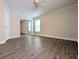 Comfortable bedroom features wood-look flooring, large mirrored closet, and natural light at 479 Little Aspen Ct, Ocoee, FL 34761