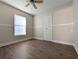 Inviting bedroom offers wood-look flooring, fresh paint, ample natural light, and a ceiling fan at 479 Little Aspen Ct, Ocoee, FL 34761