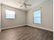 Cozy bedroom offers wood-look flooring, fresh paint, ample natural light, and a ceiling fan at 479 Little Aspen Ct, Ocoee, FL 34761