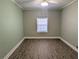 Bedroom with laminate flooring, neutral paint, and a window at 479 Little Aspen Ct, Ocoee, FL 34761