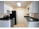 Bright kitchen with white cabinets, stainless steel appliances, and tile flooring at 479 Little Aspen Ct, Ocoee, FL 34761