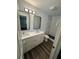 Modern bathroom featuring double sinks, marble counters, and glass-enclosed shower at 545 Brooks Ct, Polk City, FL 33868