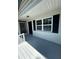Inviting front porch area with updated door and window, and with newly painted deck at 545 Brooks Ct, Polk City, FL 33868