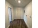 Hallway with vinyl floors, fresh paint, and utility connections at 545 Brooks Ct, Polk City, FL 33868