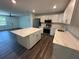 Bright and spacious kitchen with marble countertops, island, and stainless steel appliances at 545 Brooks Ct, Polk City, FL 33868