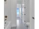 Bathroom featuring a tub with bronze fixtures, tiled floors, and an open doorway to other rooms at 10013 Brocksport Cir, Gotha, FL 34734