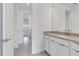 Bathroom showcasing a sink with modern fixtures, tiled floors, and doorways to other rooms at 10013 Brocksport Cir, Gotha, FL 34734