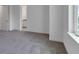 A bedroom featuring neutral carpet and white walls, with a view into another room at 10013 Brocksport Cir, Gotha, FL 34734