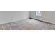 Bright bedroom featuring a window providing natural light and plush carpeting at 10013 Brocksport Cir, Gotha, FL 34734