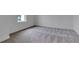 A modern bedroom featuring neutral carpeting and white walls with white baseboards at 10013 Brocksport Cir, Gotha, FL 34734