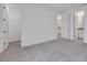 Bright bedroom featuring neutral paint, plush carpeting and multiple doorways at 10013 Brocksport Cir, Gotha, FL 34734