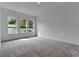 Bright bedroom with three windows offering lots of natural light and plush carpeting at 10013 Brocksport Cir, Gotha, FL 34734