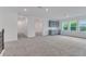 Spacious bonus room features a wet bar, windows, and neutral carpet at 10013 Brocksport Cir, Gotha, FL 34734
