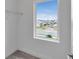 A walk-in closet with wire shelving and a window looking out to the neighborhood at 10013 Brocksport Cir, Gotha, FL 34734