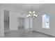 Elegant dining room with modern chandelier, tile flooring, and neutral walls for versatile decorating at 10013 Brocksport Cir, Gotha, FL 34734