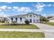 Stunning two-story home featuring a modern facade, meticulously landscaped yard, and a welcoming paver driveway at 10013 Brocksport Cir, Gotha, FL 34734