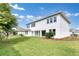 A stunning two-story white home with lush green lawn, mature trees, and pristine landscaping at 10013 Brocksport Cir, Gotha, FL 34734