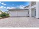 Spacious three-car garage with a paved driveway and manicured landscaping, offering both convenience and curb appeal at 10013 Brocksport Cir, Gotha, FL 34734