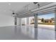 Spacious garage with high ceilings and epoxy flooring, perfect for multiple vehicles at 10013 Brocksport Cir, Gotha, FL 34734