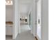 Hallway leading to the kitchen and bathroom, featuring a clean and modern design at 10013 Brocksport Cir, Gotha, FL 34734