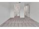 A clean and well-lit hallway with white walls and grey carpet, leading to other rooms at 10013 Brocksport Cir, Gotha, FL 34734