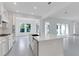 Bright white kitchen with island, stainless appliances, and an open view to the backyard at 10013 Brocksport Cir, Gotha, FL 34734
