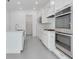 This modern kitchen is equipped with stainless appliances, white cabinets, and ample storage at 10013 Brocksport Cir, Gotha, FL 34734