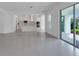 Open-concept living space with sliding glass doors and a view into the kitchen at 10013 Brocksport Cir, Gotha, FL 34734