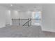 Open loft area with a railing overlooking the lower level at 10013 Brocksport Cir, Gotha, FL 34734